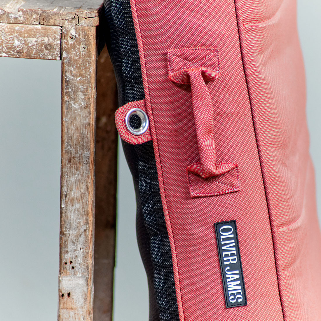 The trims of a red luxury pool float leaning against a stool in a warehouse.