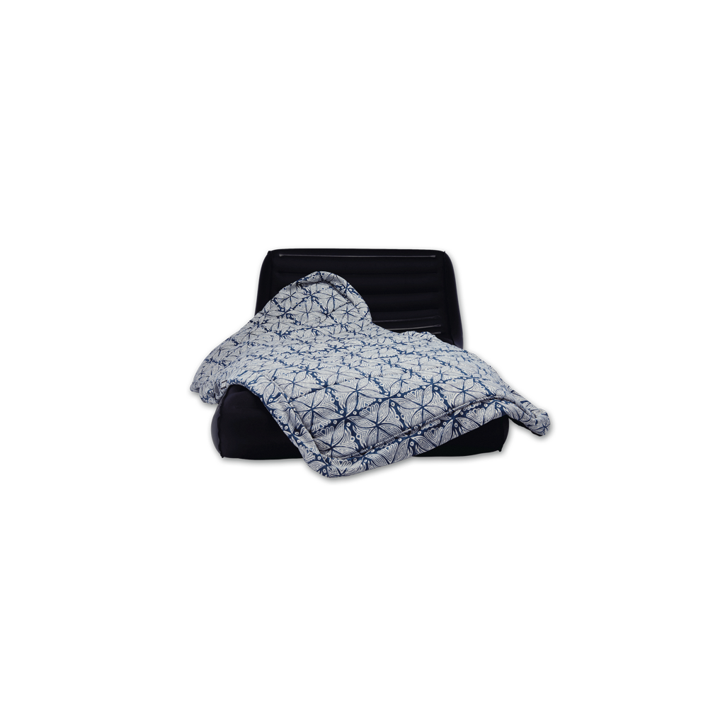 A blue and white patterned luxury pool float cover draped over a TPU inflatable core.