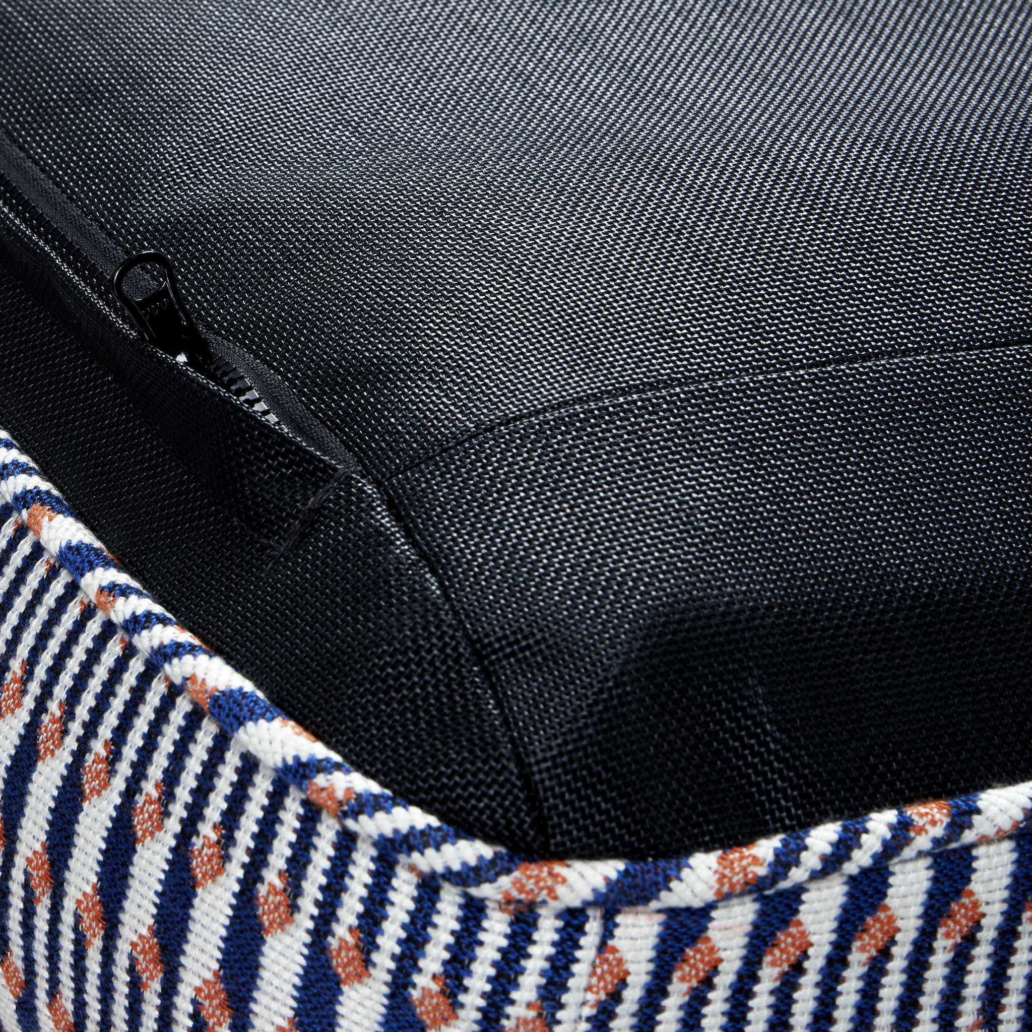 An upside down blue, white and orange luxury pool float lounger displaying the zipper, base and stitching.