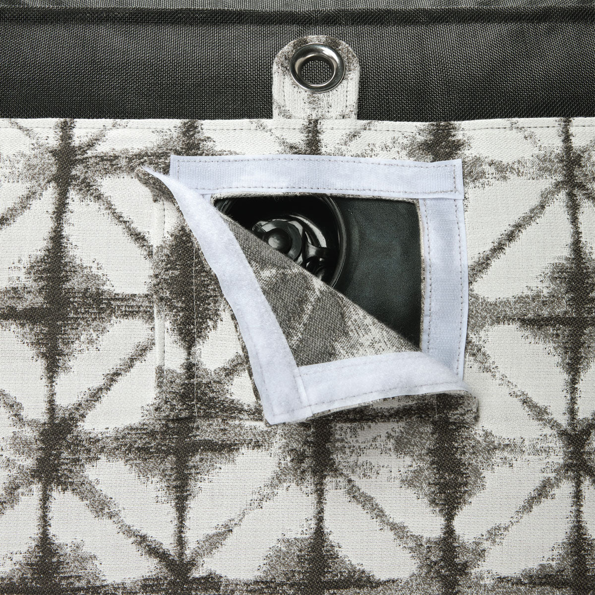 A pool float for an adult in a grey and white fabric upside down with a eyelet and velcro window showing a boston valve.  