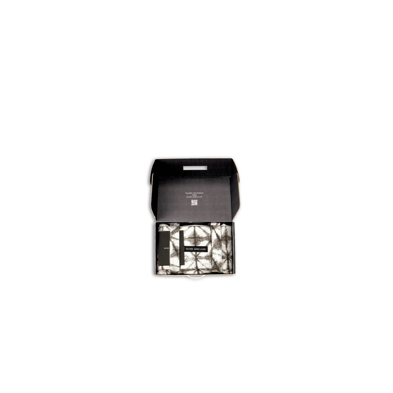 Un hamac de luxe Lilo plié dans une petite boîte noire avec le couvercle ouvert.