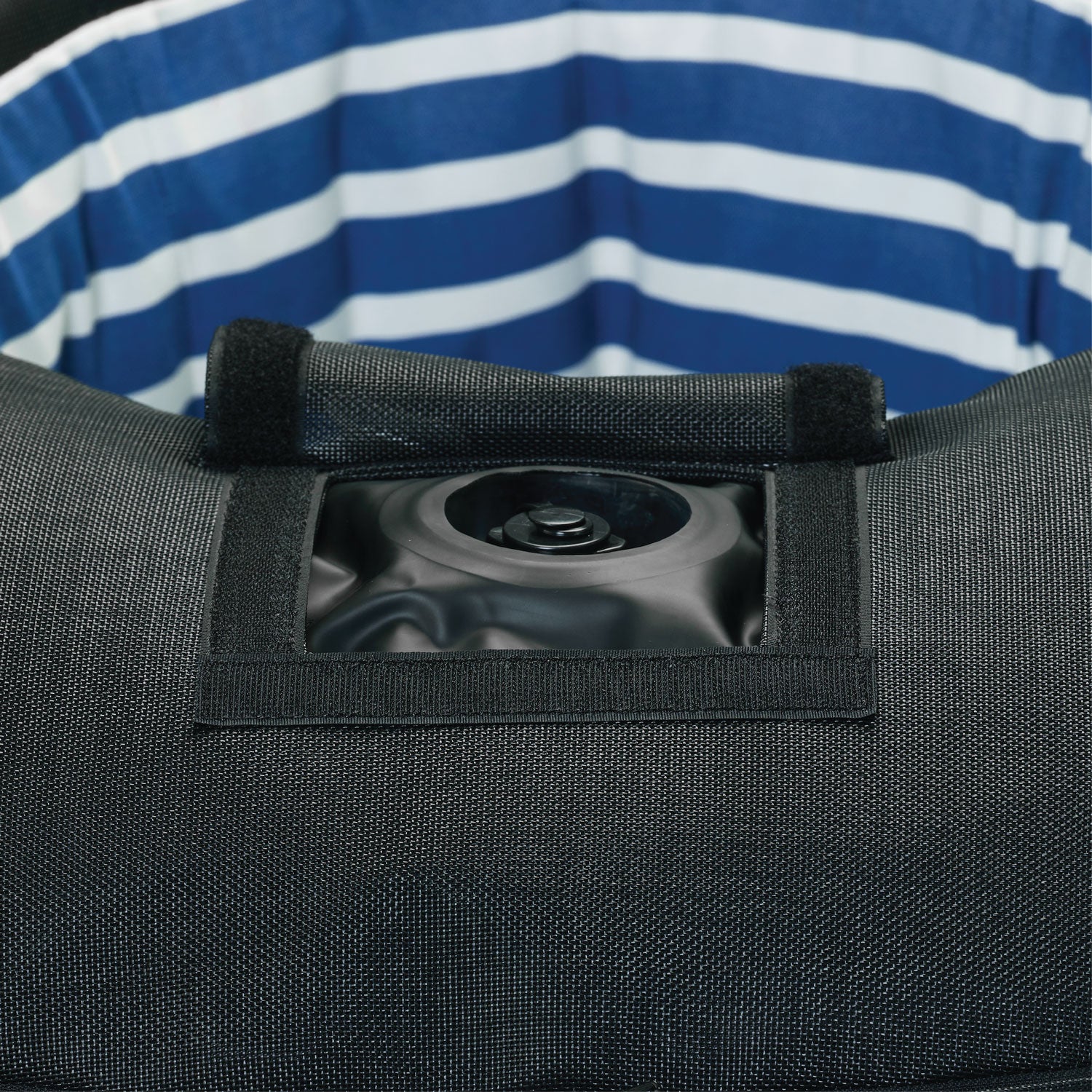 A ring luxury lilo in blue and white stripe upside down displaying the base and velcro window to access the boston valve.