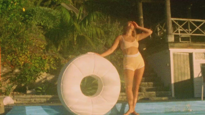 Ring luxury pool float loungers for adults in and around a swimming pool edited using both super eight and digital video clips.